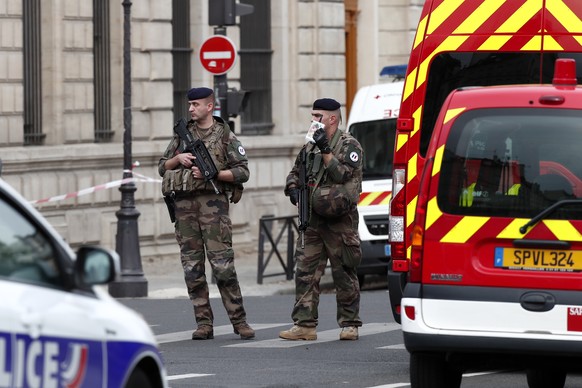 epa07891619 Military forces establish a security perimeter near Paris police headquarters after a man has been killed after attacking officers with a knife in Paris, France, 03 October 2019. According ...