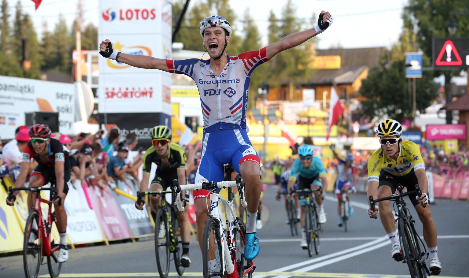 epa06938904 Austrian cyclist Georg Preidler (C) of the Groupama-FDJ team celebrates after crossing the finish line to win the fifth stage of the 75th Tour de Pologne 2018 cycling race over 129 km from ...
