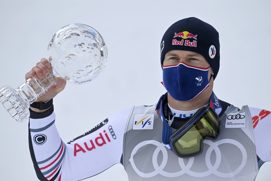 Alexis Pinturault of France celebrates with the crystal globe of the overall men&#039;s Super-G competition during the podium ceremony after the men&#039;s Super-G race at the FIS Alpine Skiing World  ...