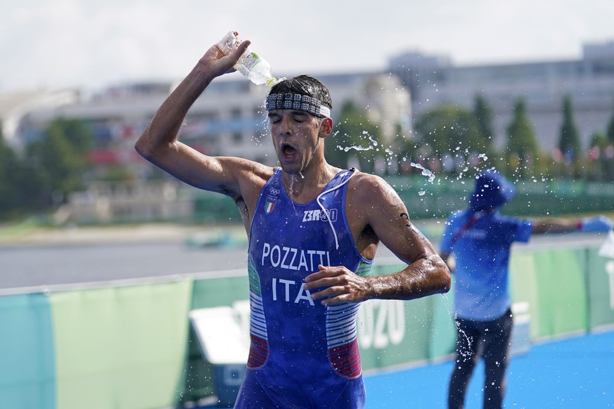 Gianluca Pozzatti of Italy takes water as he competes in the run portion of the men&#039;s individual triathlon at the 2020 Summer Olympics, Monday, July 26, 2021, in Tokyo, Japan. (AP Photo/Jae C. Ho ...