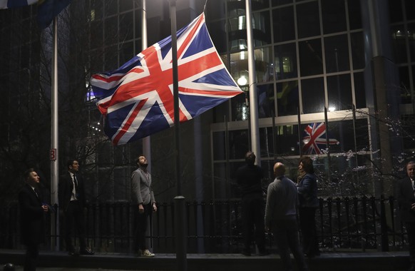 FILE - In this Friday, Jan. 31, 2020 file photo, the Union flag is lowered and removed from outside of the European Parliament in Brussels. It