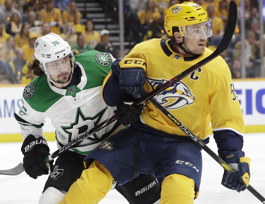 Dallas Stars center Matts Zuccarello (36), of Norway, and Nashville Predators defenseman Roman Josi (59), of Switzerland, vie for the puck during the first period in Game 1 of an NHL hockey first-roun ...