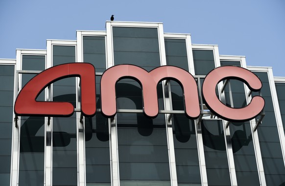 FILE - In this April 29, 2020 file photo, the AMC sign appears at AMC Burbank 16 movie theater complex in Burbank, Calif. AMC Theaters, the nation���s largest chain, is pushing back its plans to begin ...