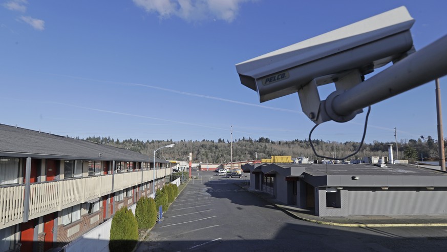 FILE - In this March 4, 2020 file photo, a security camera is shown on the second floor of a row of rooms at a motel in Kent, Wash. Hackers aiming to call attention to the dangers of mass surveillance ...