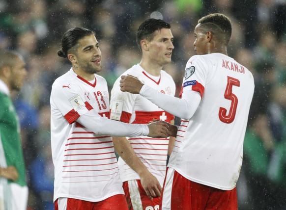 Switzerland&#039;s Ricardo Rodriguez, left, celebrates with Manuel Akanji after the World Cup qualifying play-off first leg soccer match between Northern Ireland and Switzerland at Windsor Park in Bel ...