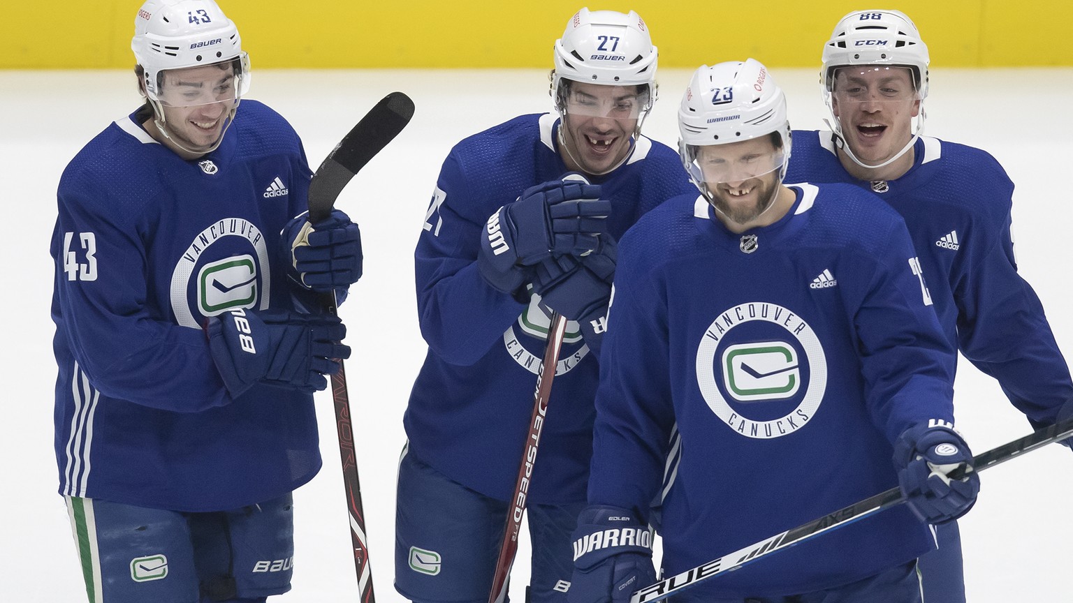 From left to right, Vancouver Canucks defensemen Quinn Hughes, Travis Hamonic, Nate Schmidt and Alexander Edler, of Sweden, laugh during the NHL hockey team&#039;s training camp in Vancouver, British  ...