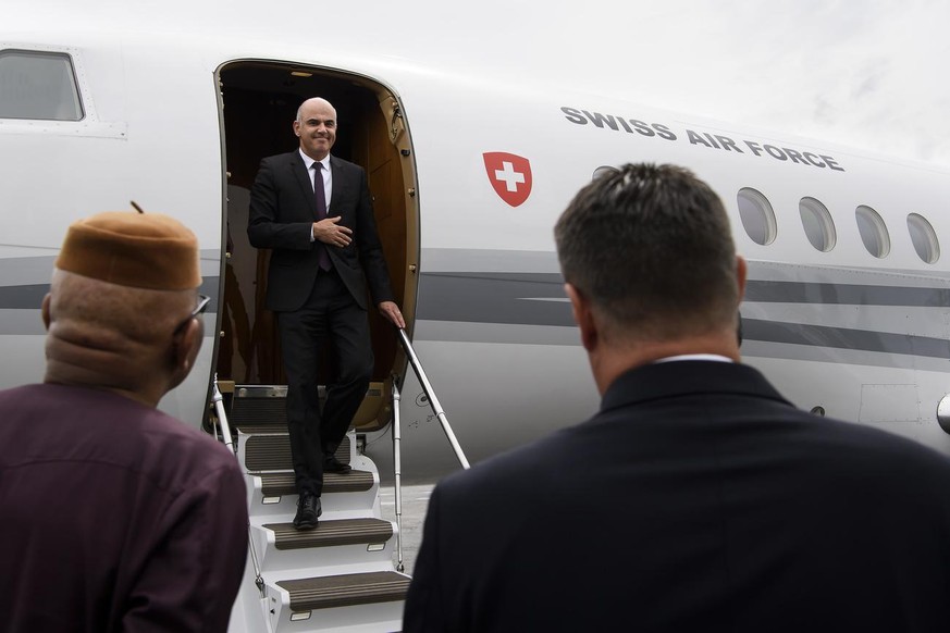 Swiss Federal Councillor Alain Berset, center, gets off the plane, next to Pietro Lazzeri, Ambassador of Switzerland to the Republic of Cameroon, the Republic of Equatorial Guinea and the Central Afri ...