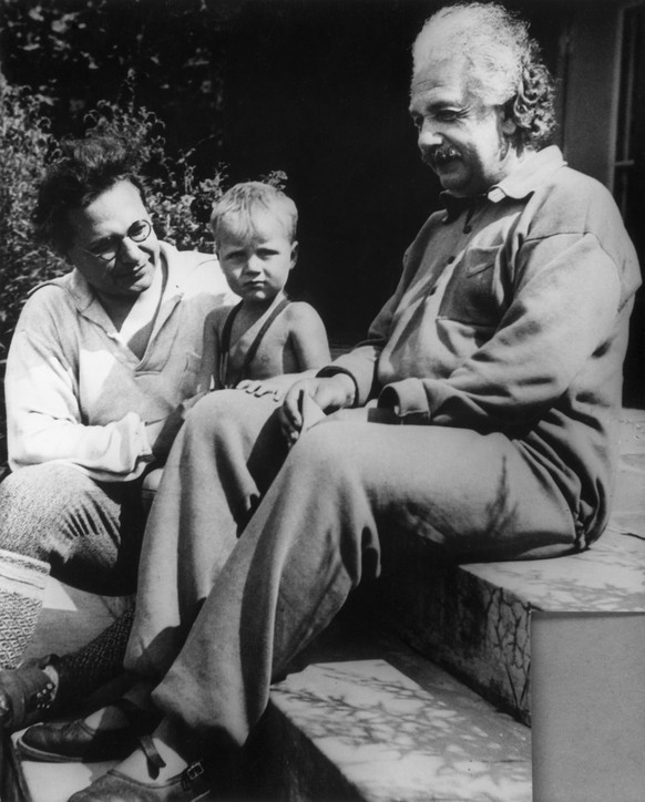 16th February 1936: Full-length portrait of German-born physicist Albert Einstein (1879-1955) with his son Hans Albert, left, (1904 - 1973) and grandson Bernhard sitting on steps. (Photo by American S ...
