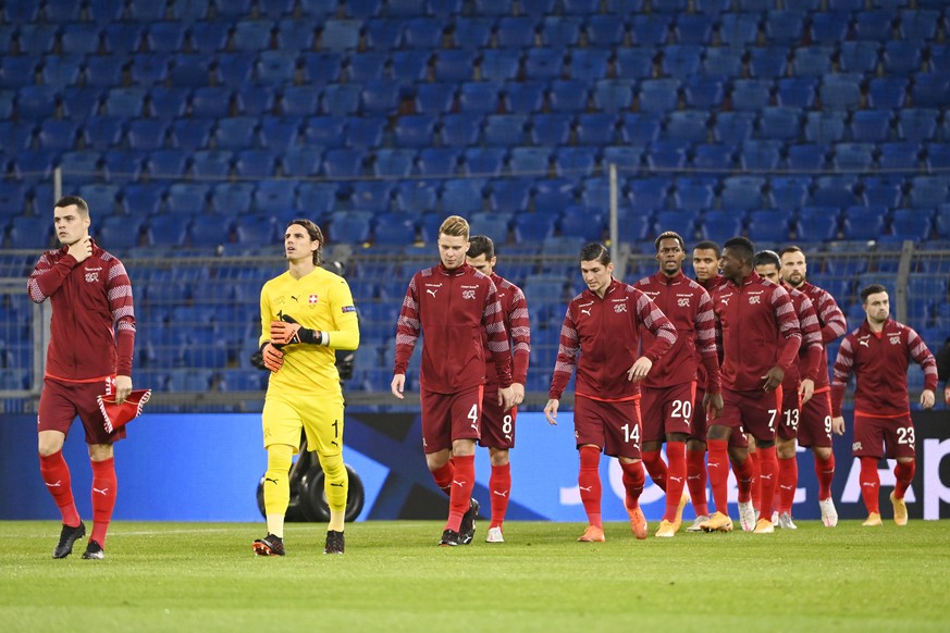 The Swiss players led by their captain Granit Xhaka, left, and goalkeeper Yann Sommer, enter the pitch ahead of the UEFA Nations League group 4 soccer match between Switzerland and Spain at the St. Ja ...