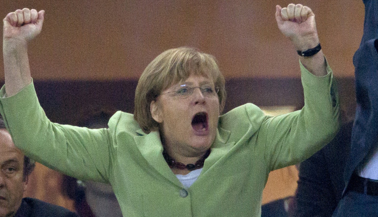 FILE - In this June 22, 2012 file photo German Chancellor Angela Merkel celebrates during the Euro 2012 soccer championship quarterfinal match between Germany and Greece in Gdansk, Poland. Germany won ...