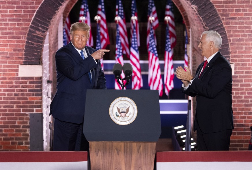 epa08628204 US President Donald J. Trump (L) points to Vice President Mike Pence (R) as he arrives on stage after Pence delivered remarks on the third night of the Republican National Convention, at F ...
