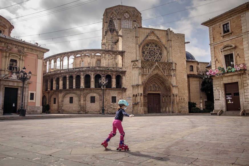 epa08385431 A child skates on a deserted square amid the ongoing coronavirus COVID-19 pandemic in Valencia, Spain, 26 April 2020, on the first day that minors have been allowed for an hour a day outsi ...