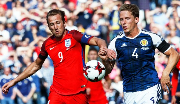 epa06021276 Harry Kane (L) of England in action against Christophe Berra (R) of Scotland during the FIFA World Cup 2018 group F qualifying soccer match between Scotland and England at Hampden Park in  ...