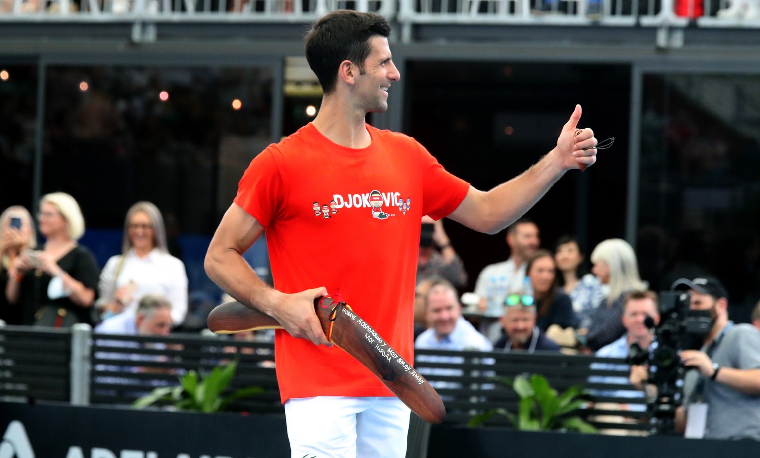 epa08972275 Novak Djokovic of Serbia receives an Aboriginal carving during the &#039;A Day at the Drive&#039; tennis event at Memorial Drive Tennis Centre in Adelaide, Australia, 29 January 2021. EPA/ ...