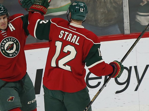 Minnesota Wild&#039;s Zach Parise celebrates with teammate Eric Staal (12) after Parise scored a goal against the Florida Panthers in the first period of an NHL hockey game,Tuesday, Dec. 13, 2016, in  ...