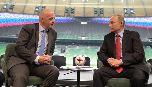 epa05984073 Russian President Vladimir Putin (R) speaks with FIFA President Gianni Infantino (L) while visiting the FK Krasnodar stadium in Krasnodar, southern Russia, 23 May 2017. EPA/ALEXEI DRUZHINI ...