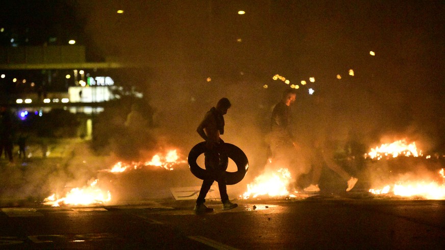 epa08632904 Demonstrators burn tyres as protesters riot in the Rosengard neighbourhood of Malmo, Sweden, on 28 August 2020. The protest was sparked by the burning of a Koran by members of Danish far-r ...