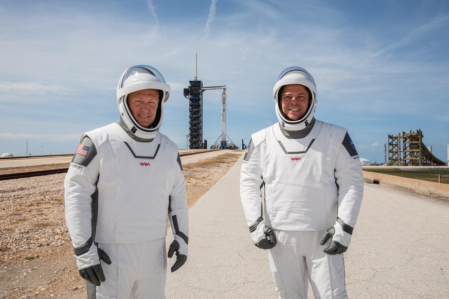 epa08447053 (FILE) - A handout photo made available by NASA shows NASA astronauts Douglas Hurley (L) and Robert Behnken (R) participating in a dress rehearsal for a launch at Kennedy Space Center in F ...