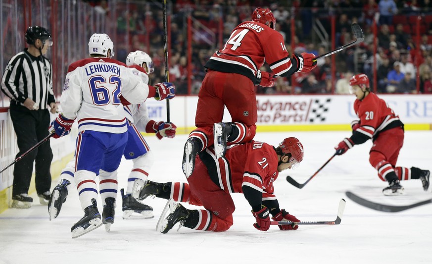 Carolina Hurricanes&#039; Justin Williams (14) jumps over teammate Nino Niederreiter (21), of the Czech Republic, while Montreal Canadiens&#039; Artturi Lehkonen (62), of Finland, chases the puck duri ...