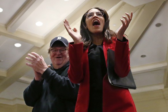 Rep. Alexandria Ocasio-Cortez, D-N.Y., right, greets the crowd as she arrives to speak as a surrogate for Democratic Presidential Candidate Bernie Sanders Friday, Jan.24, 2020, in Iowa City, Iowa. At  ...