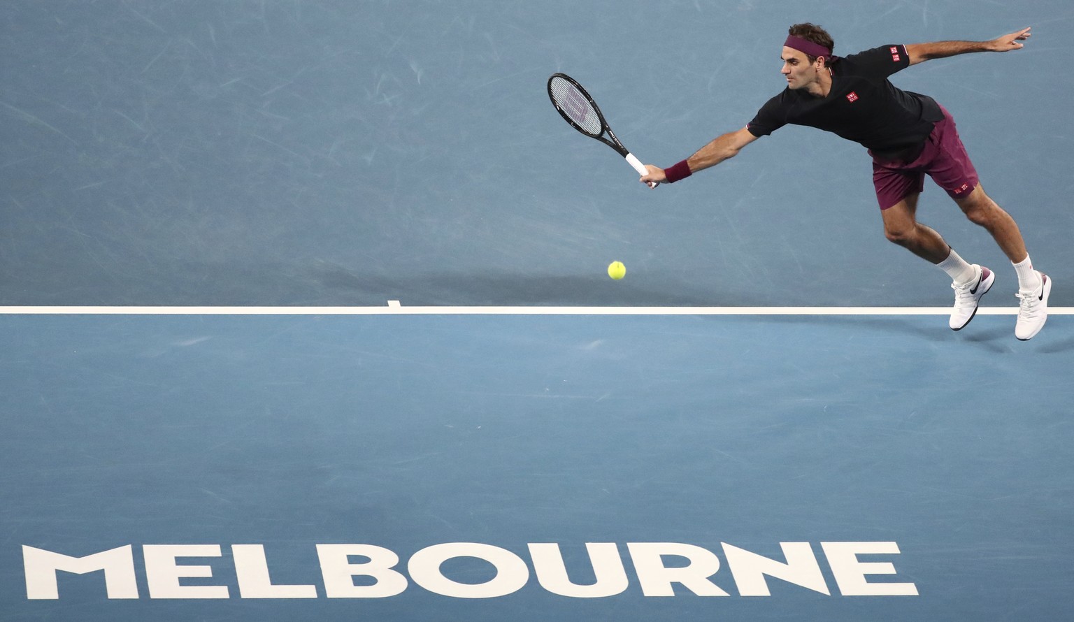 Switzerland&#039;s Roger Federer attempts to make a backhand return to Serbia&#039;s Novak Djokovic during their semifinal match at the Australian Open tennis championship in Melbourne, Australia, Thu ...