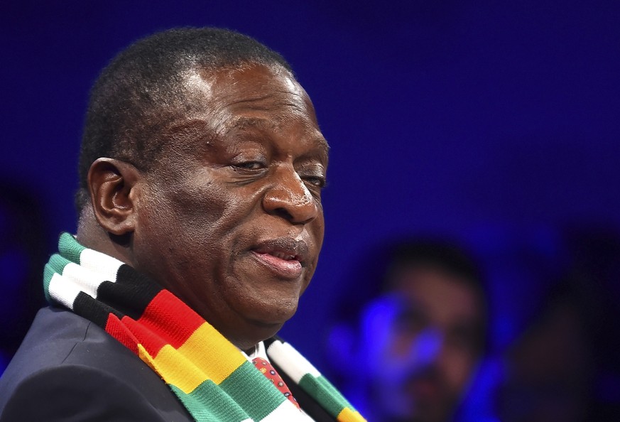 Zimbabwean President Emmerson Mnangagwa, wearing scarf, arrives at the World Economic Forum on Africa in Cape Town South Africa, Wednesday, Sept 4, 2019. Mnangagwa is attending the three-day summit th ...