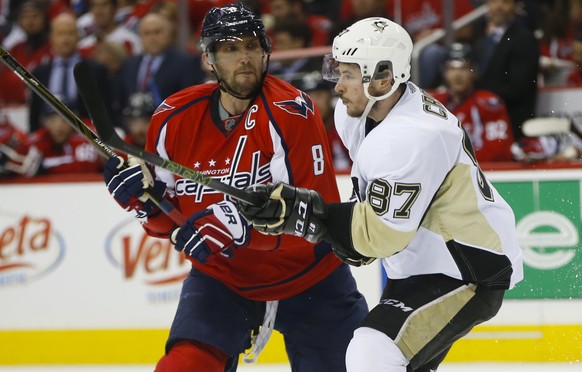 Washington Capitals left wing Alex Ovechkin (8) goes up against Pittsburgh Penguins center Sidney Crosby (87) during the second period of Game 1 in an NHL hockey Stanley Cup Eastern Conference semifin ...