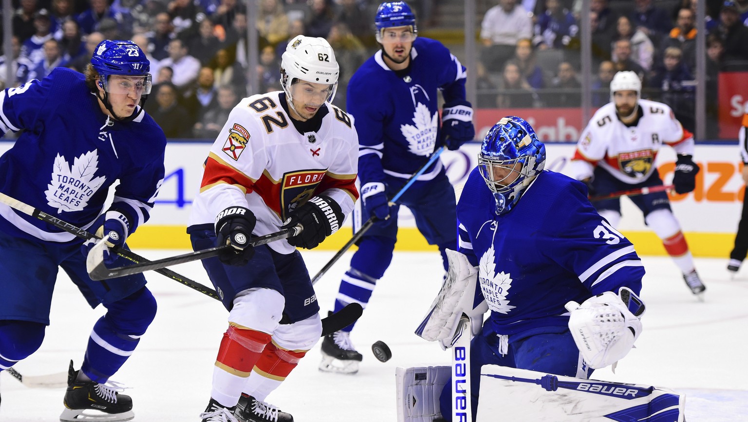 Florida Panthers center Denis Malgin (62) moves in on Toronto Maple Leafs goaltender Frederik Andersen (31) as Maple Leafs Travis Dermott (23) defends during the first period of an NHL hockey game, Mo ...