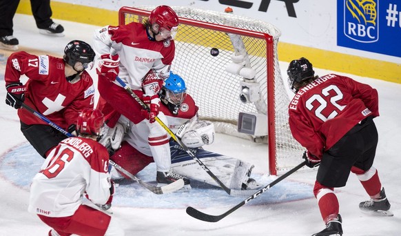 Switzerland&#039;s Nando Eggenberger, right, scores past Denmark goaltender Lasse Petersen during the second period of a World Junior hockey tournament game Friday, Dec. 30, 2016 in Montreal. (Paul Ch ...