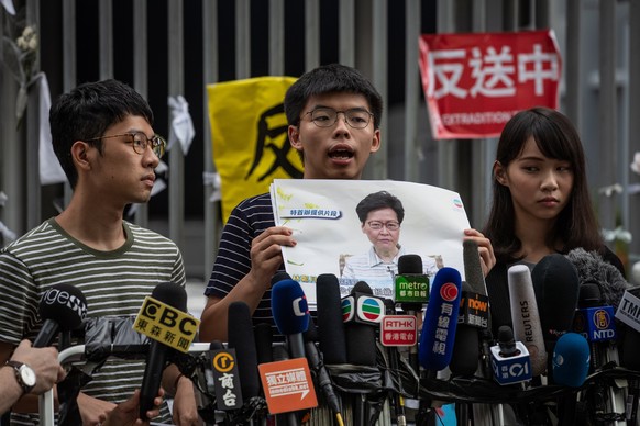 epa08516934 (FILE) - Pro-democracy activists (L-R) Nathan Law, Joshua Wong and Agnes Chow attend a press conference outside the Legislative Council building in Hong Kong, China, 18 June 2019 (reissued ...
