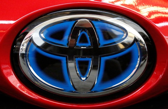 FILE- This Feb. 15, 2018, file photo shows the Toyota logo on the trunk of a 2018 Toyota Prius on display at the Pittsburgh Auto Show. Toyota Motor Corp. reported Tuesday, May 12, 2020 a sharp plunge  ...