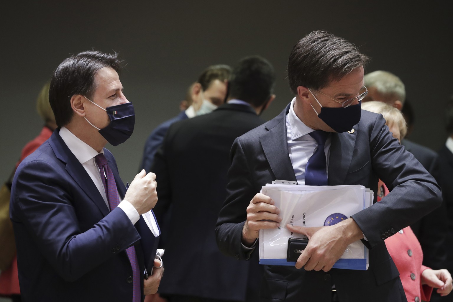 Italy&#039;s Prime Minister Giuseppe Conte, left, speaks with Dutch Prime Minister Mark Rutte during a round table meeting at an EU summit in Brussels, Friday, July 17, 2020. Leaders from 27 European  ...