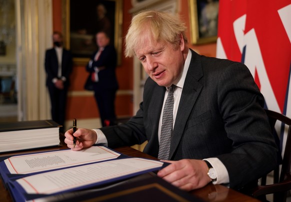 epa08911632 A handout photo made available by n10 Downing street shows Britain&#039;s Prime Minister Boris Johnson after signing the Trade and Cooperation Agreement between the UK and the EU, the Brex ...