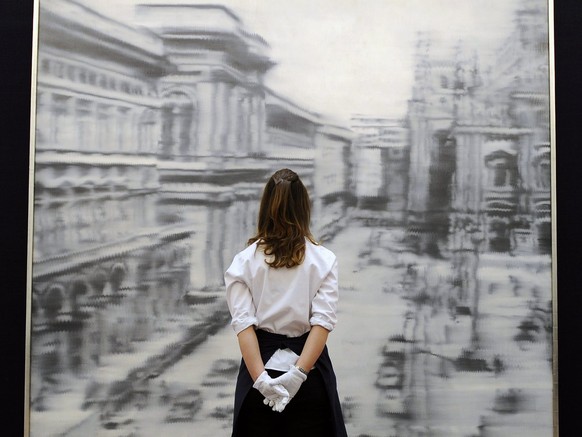 epa03659289 A Sotheby&#039;s auction house staff looks over the artwork &#039;Domplatz, Mailand&#039; (1968) by German artist Gerhard Richter during a media preview at Sotheby&#039;s auction house in  ...