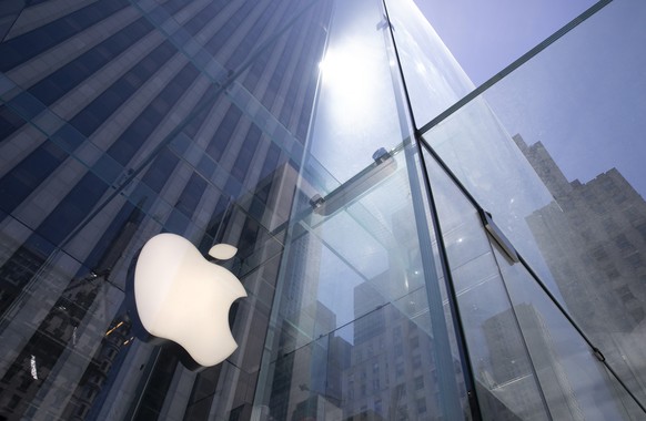 FILE - In this June 16, 2020 file photo, the sun is reflected on Apple&#039;s Fifth Avenue store in New York. Apple is the first U.S. company to boast a market value of $2 trillion, just two years aft ...