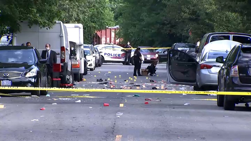 In this image from video provided by NBC4 Washington, law enforcement work the scene of a shooting, Sunday, Aug. 9, 2020, in Southeast Washington. (NBC4 Washington via AP)