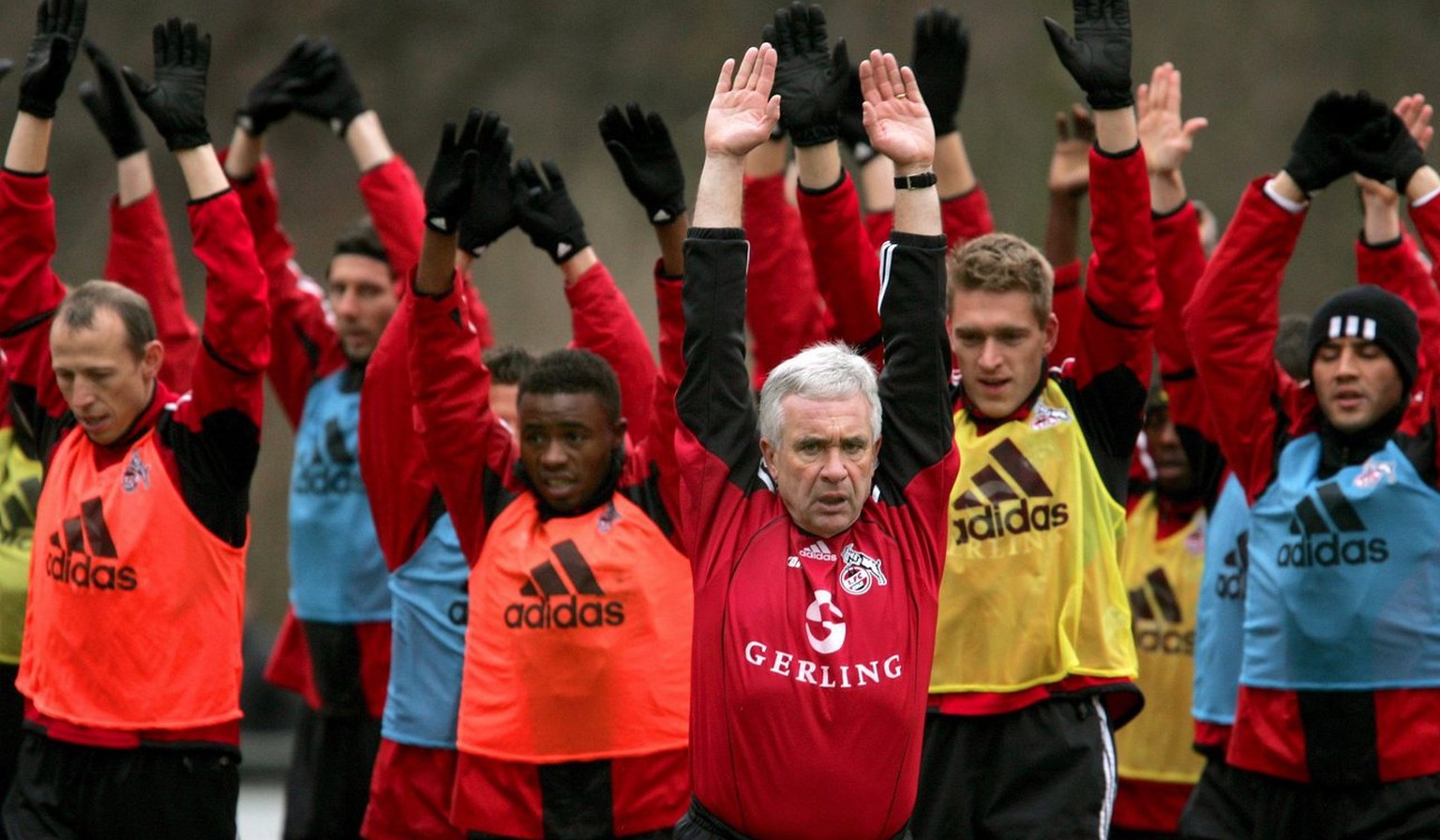 German Bundesliga club 1.FC Cologne&#039;s new head coach Hanspeter Latour (C) does some gymnastics with his players during his first training session with the team after the winter break in Cologne,  ...
