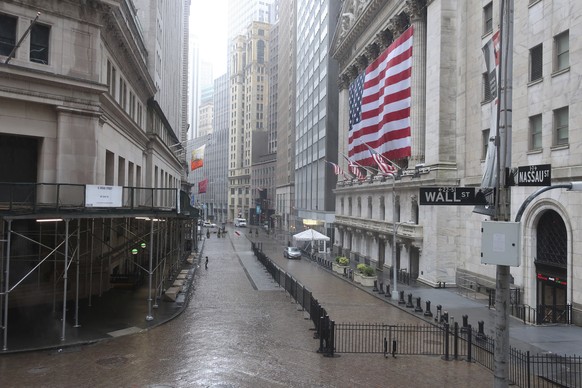 The normally busy area of Wall Street at the New York Stock Exchange is empty on a rainy day in New York, Monday, April 13, 2020. Gov. Andrew Cuomo says New York&#039;s death toll from coronavirus has ...