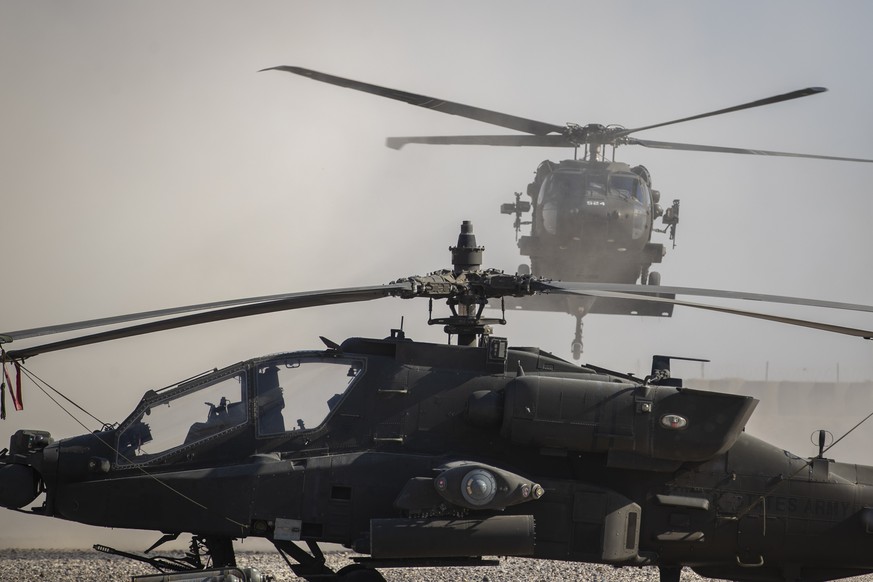 A Blackhawk helicopter lands next to an Apache attack helicopter at a U.S. military base at undisclosed location in Eastern Syria, Monday, Nov. 11, 2019. A senior U.S. coalition commander said Friday, ...