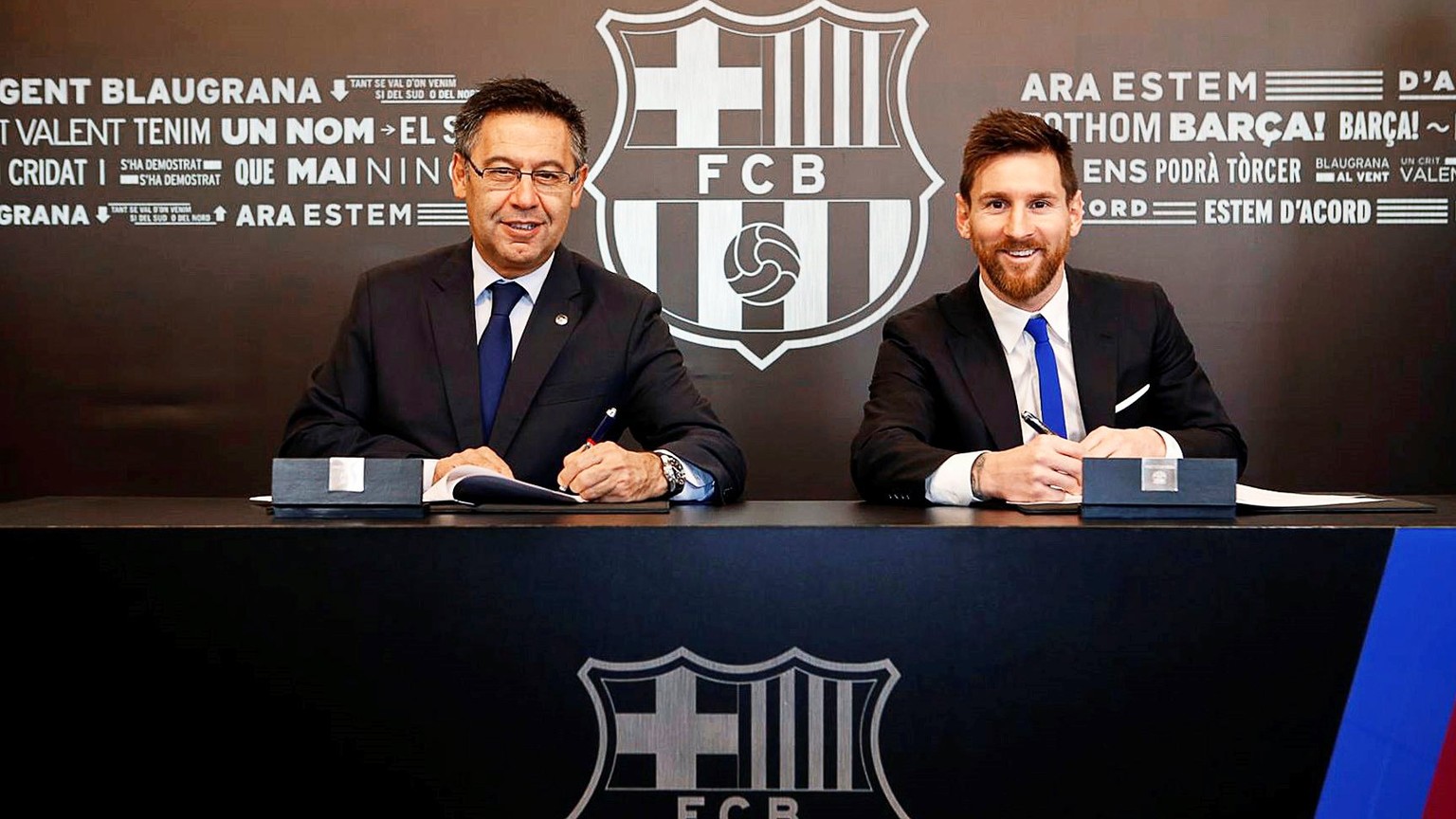 epa06349647 A handout photo made available by Spanish Primera Division soccer club FC Barcelona of Argentine striker Lionel Messi (R) signing his new contract next to Barcelona&#039;s president Josep  ...