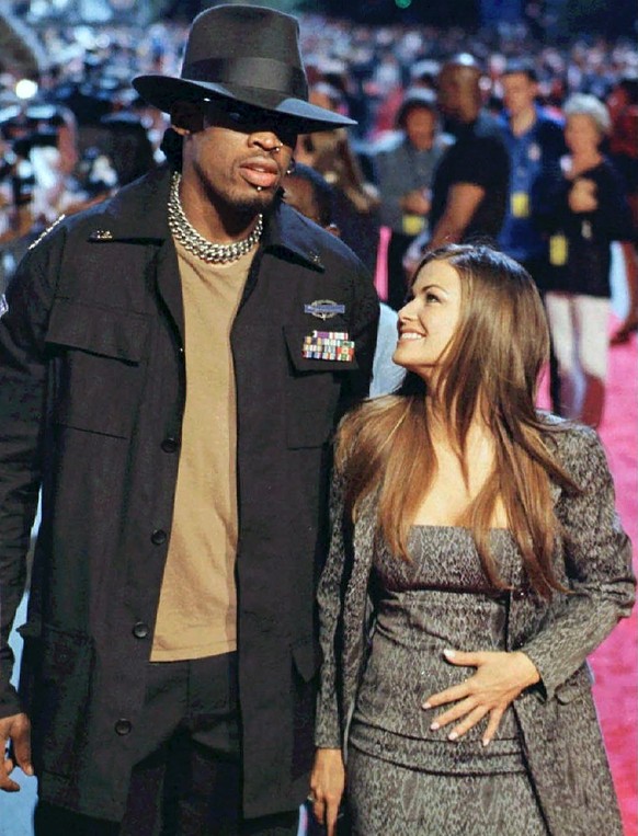 FILE - In this July 27, 1998, file photo, Chicago Bulls star Dennis Rodman and Carmen Electra are shown arriving at the opening of the Planet Hollywood restaurant in Montreal. Carmen ElectraÄôs relat ...