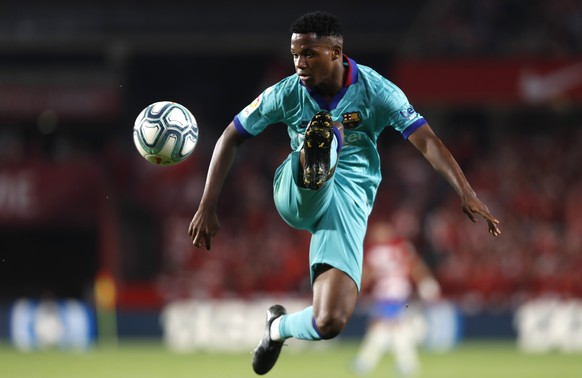 FILE - In this Saturday, Sept. 21, 2019 file photo, Barcelona&#039;s Ansu Fati controls the ball during the Spanish La Liga soccer match between Barcelona and Granada at the Los Carmenes stadium in Gr ...
