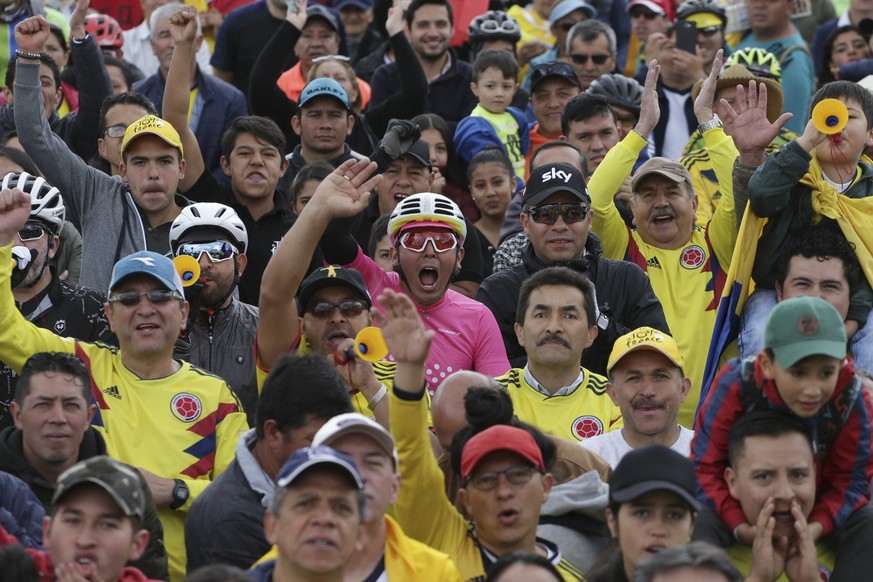 Cycling fans celebrate as they watch on a giant screen Colombia&#039;s Egan Bernal performance in the twentieth stage of the Tour de France cycling race at his hometown in Zipaquira, Colombia, Saturda ...