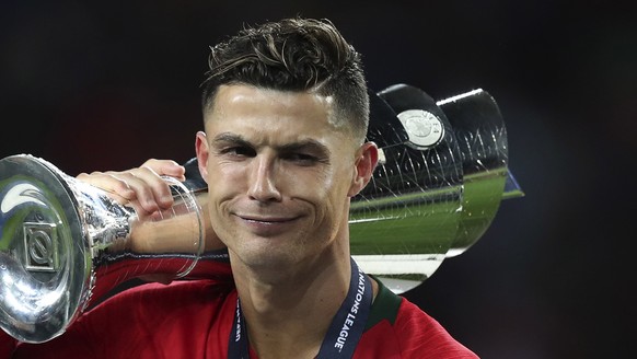 epa07637835 Portugal player Cristiano Ronaldo celebrates with the trophy after winning the UEFA Nations League final soccer match Portugal vs Netherlands at Dragao stadium, Porto, Portugal, 09 June 20 ...