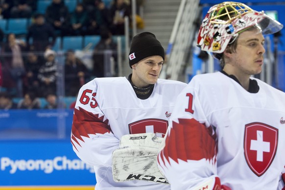Leonardo Genoni, goalkeeper of Switzerland, and Jonas Hiller, goalkeeper of Switzerland, from left, react after the men ice hockey preliminary round match between Switzerland and Czech Republic in the ...