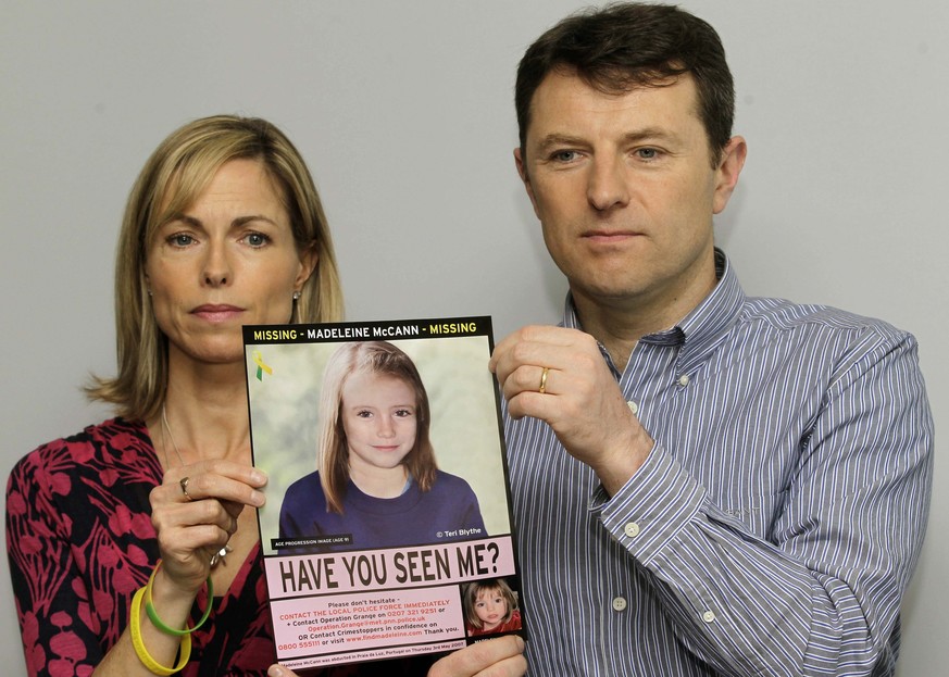 FILE - In this May 2, 2012 file photo, Kate and Gerry McCann pose for the media with a missing poster depicting an age progression computer generated image of their daughter Madeleine at nine years of ...