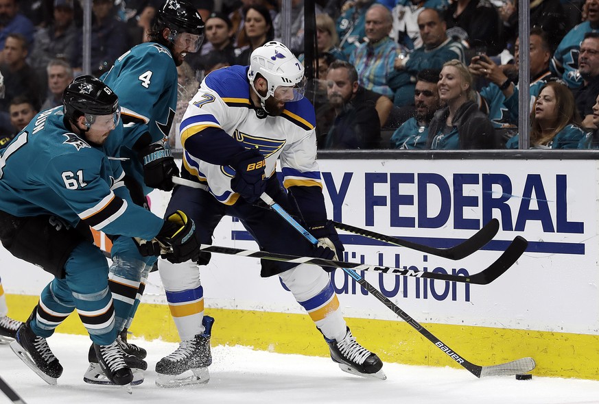 St. Louis Blues&#039; Pat Maroon, right, moves the puck past San Jose Sharks&#039; Justin Braun, left, and Brenden Dillon (4) during the second period in Game 2 of the NHL hockey Stanley Cup Western C ...