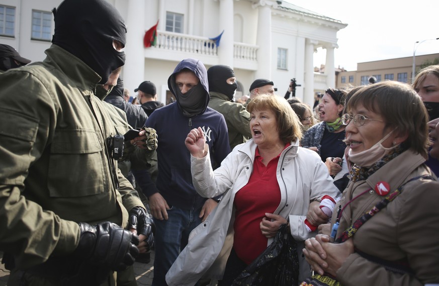 A woman gestures, standing in front of police line during an opposition rally to protest the official presidential election results in Minsk, Belarus, Saturday, Sept. 12, 2020. (Tut.by via AP)
