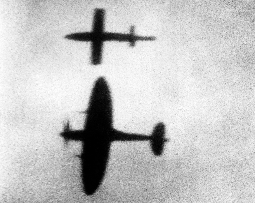 epa06641583 A handout provided by the Air Historical Branch-RAF (Royal Air Force) of a photograph, taken from the ground on 09 August 1944, showing a Spitfire closing in on a V1 bomb and safely tippin ...
