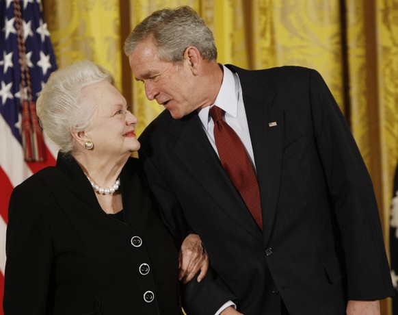 FILE - In this file photo dated Monday, Nov. 17, 2008, US President George W. Bush greets actress Olivia de Havilland as he presented her with the 2008 National Medals of Arts, in the East Room of the ...